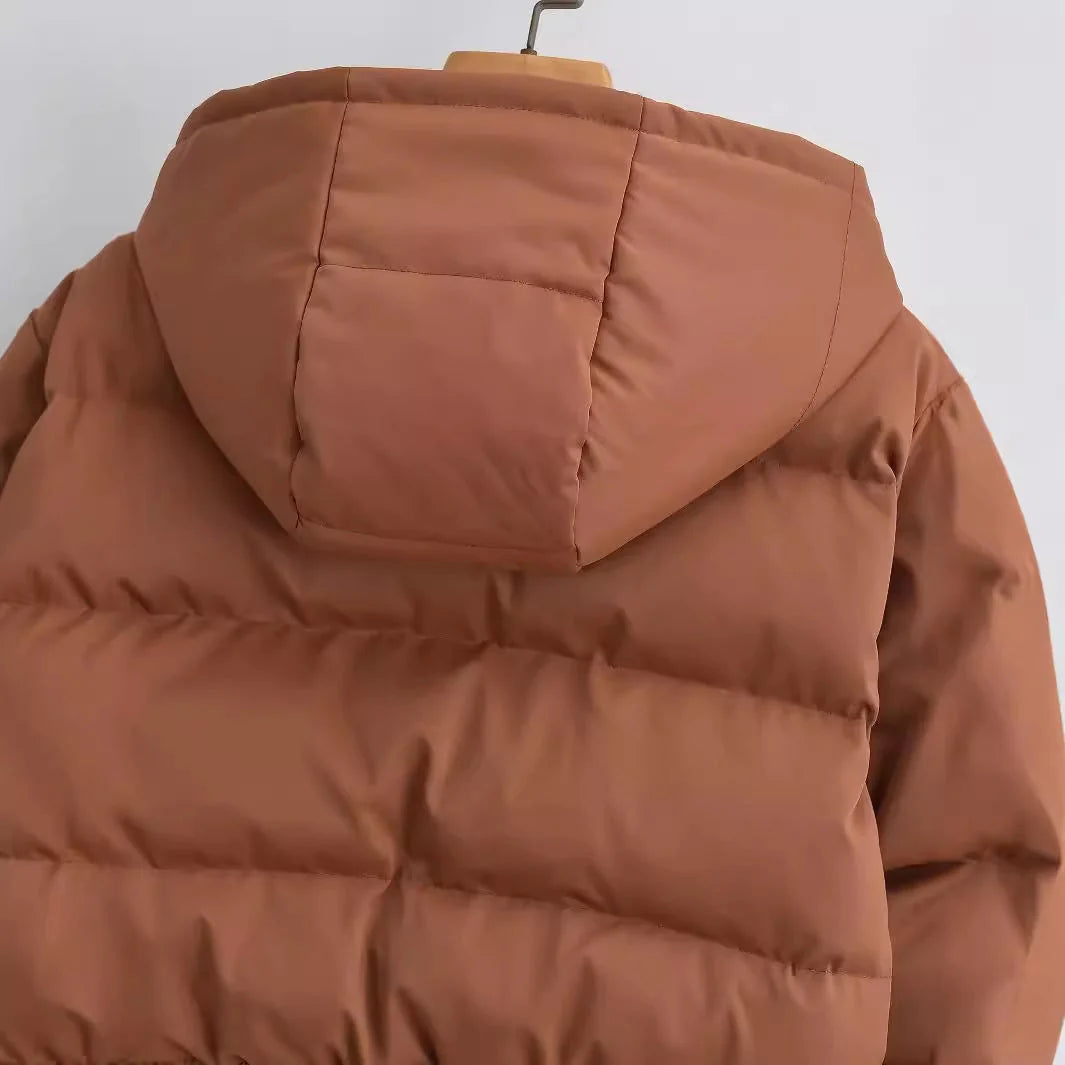 Detail van de stormflap met drukknopen over de rits