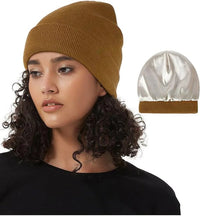 Vrouw draagt de gebreide muts met satijnen voering in camel, met zicht op de satijnen binnenkant