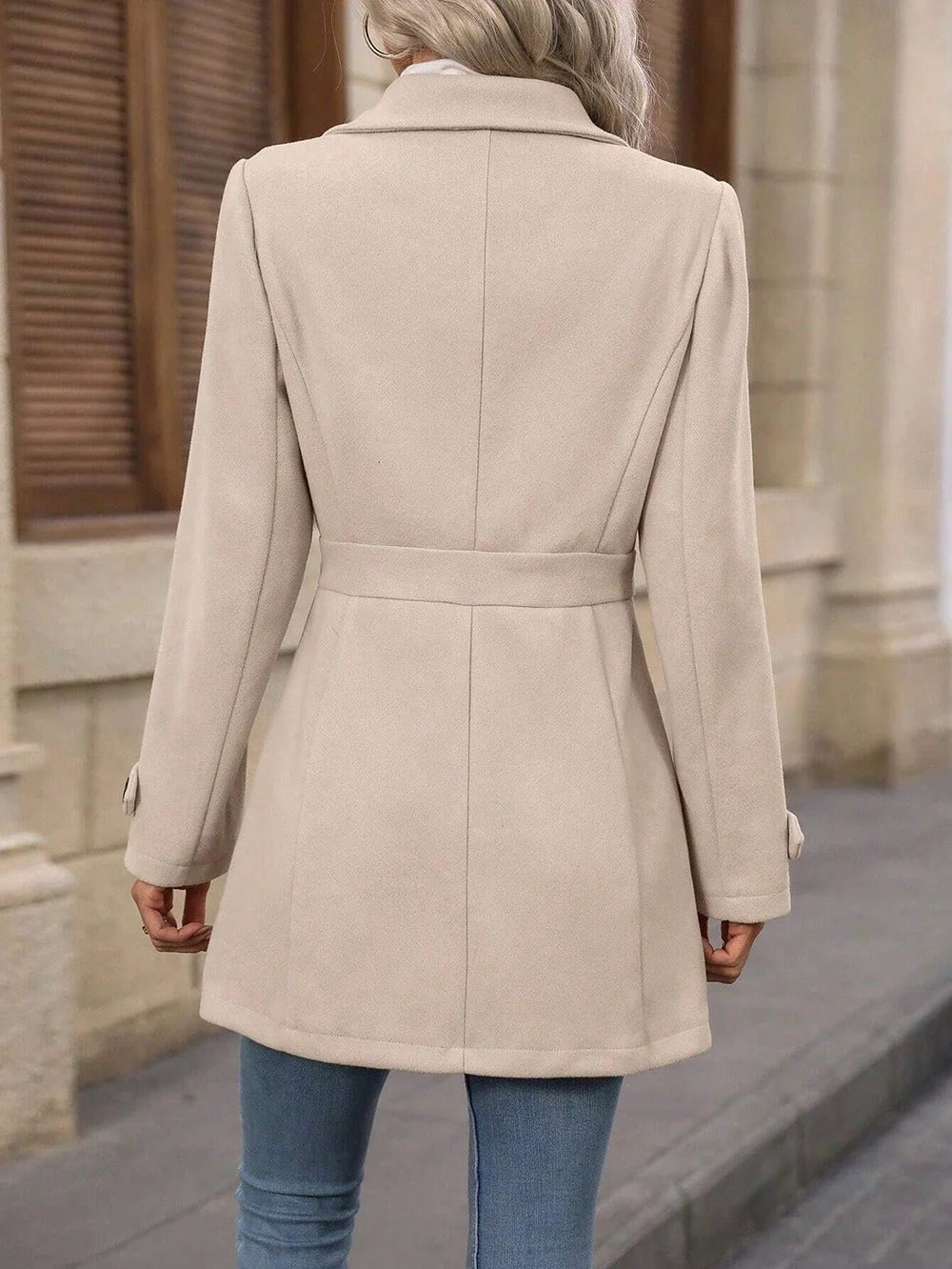 Achterkant van korte trenchcoat met tailleband over het rugpand