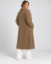 Achterkant van lange taupe teddy jas voor dames
