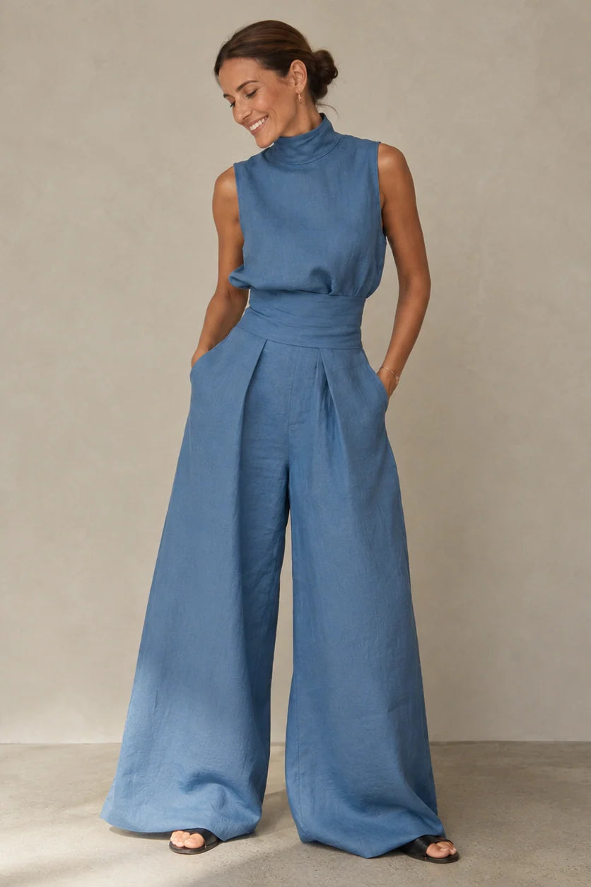 Blauwe jumpsuit met palazzo pijpen en zakken in de zijnaad