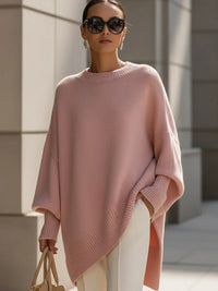 Roze gebreide poncho met lange geribde manchetten