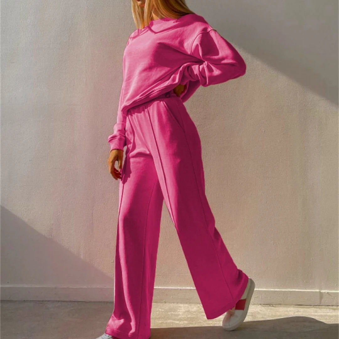 Roze tweedelig joggingpak dames met wijde pijpen en persvouw